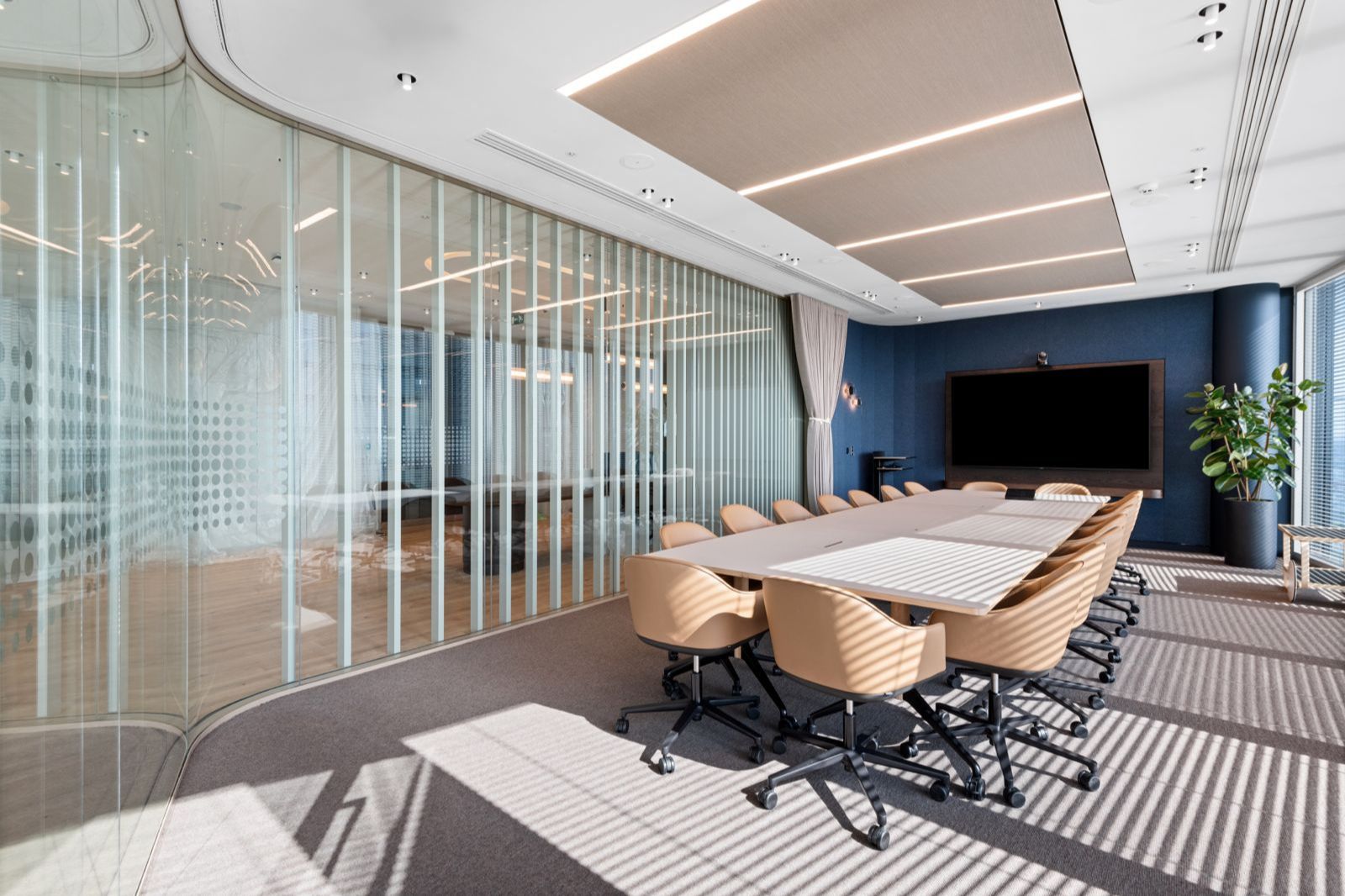 Concept100 glazed boardroom partitioning within a contemporary workplace.
