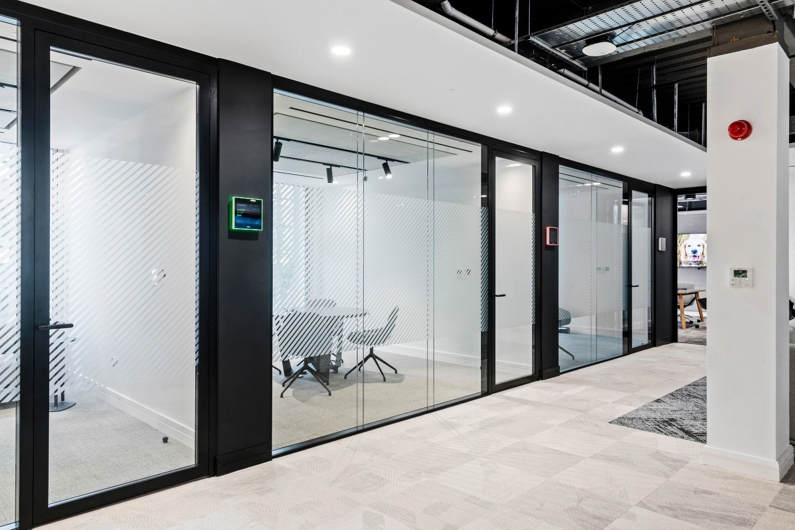 Black framed glazed office partitions and doors.